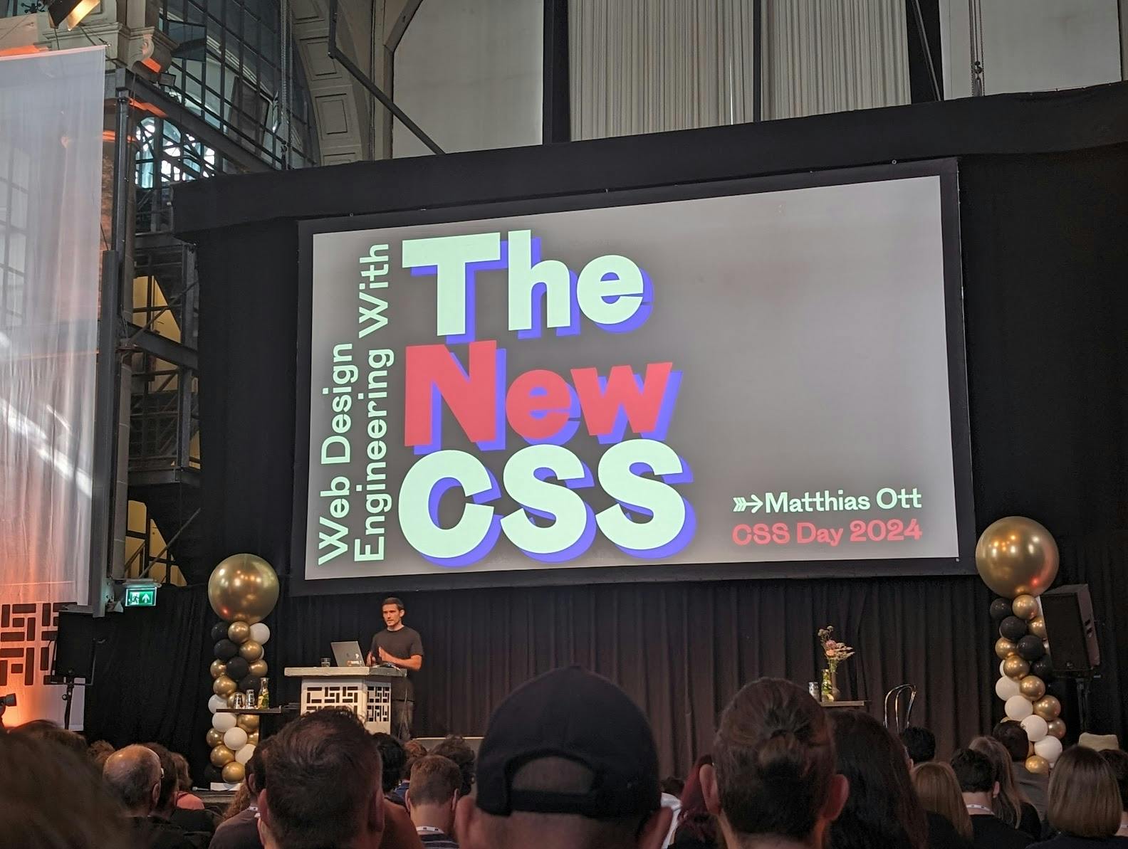 Mathias Ott in front of a slide with text: The New CSS
